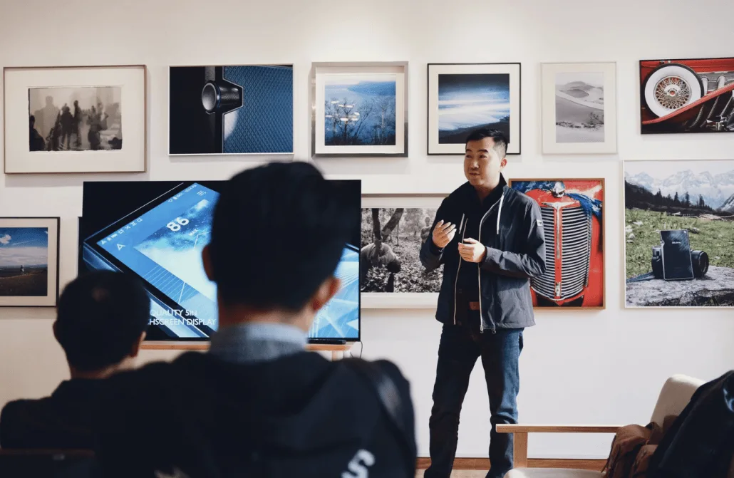 Man giving a lecture on the history of mobile photography